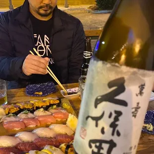 a man eating sushi with chopsticks