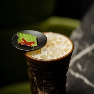 coco-rashi cocktail with whisky, coconut, maracuya, dill, mango, nigori, wine, japanese mustard, and citrus