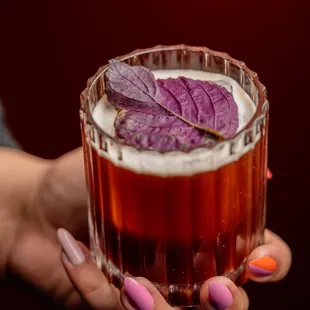 ume-uva cocktail with rum, pisco, shiso, szechuan, ume, grape, and lemon