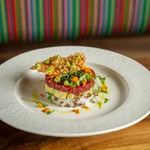 bluefin poke tower, bluefin tuna, cucumbers, avocado cream, aji amarillo, ginger vinaigrette