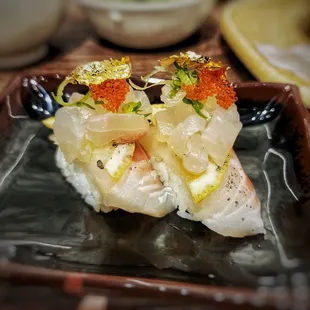 Japanese snapper, lemon slice, masago, and gold flakes. Chef is creative.
