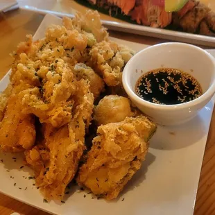 a plate of fried food and a bowl of dipping sauce