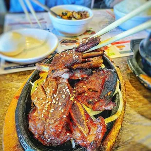 a plate of food with chopsticks