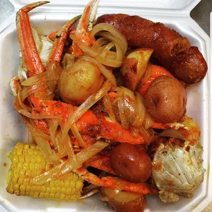 Boiled snow crab with corns, sausage, and potatoes