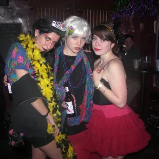 three people dressed up for a party