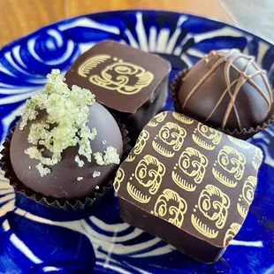 three chocolates on a blue plate