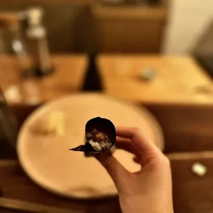 a person holding a piece of food