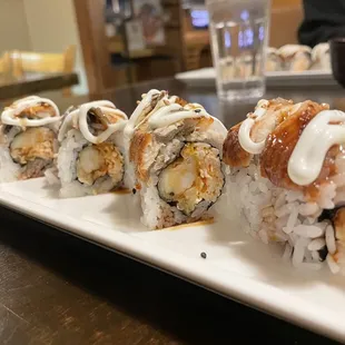 Jin&apos;s choice - spicy crab, shrimp tempura inside, eel on top with white sauce.