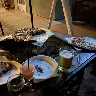 Elk pizza, hatch cheese pizza, microbrew beer, and a Hawaiian rum drink.