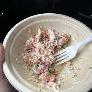 a person holding a fork in a bowl