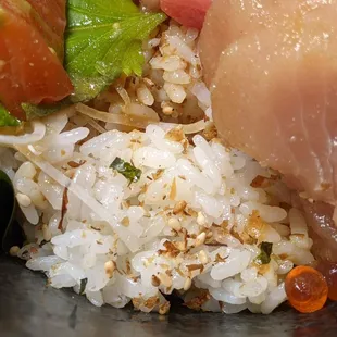Chirashi rice has some furikake sprinkled on it