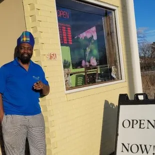a man standing in front of a restaurant
