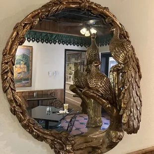a mirror with two peacocks on it