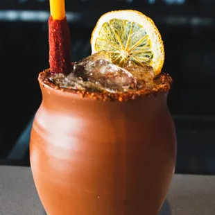 a cocktail in a clay pot