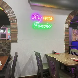 One of several neon signs in restaurant.