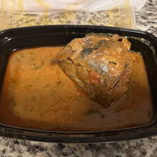 a bowl of curry with meat