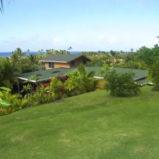A view from above the property overlooking the roofline out over the ocean