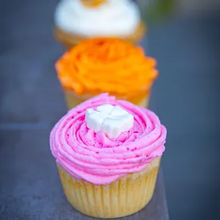 Cupcakes - guava (pink), mango with li hing mui (orange), macadamia nut banana (white).
