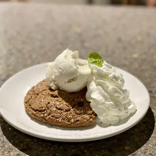 a chocolate cookie with whipped cream on top