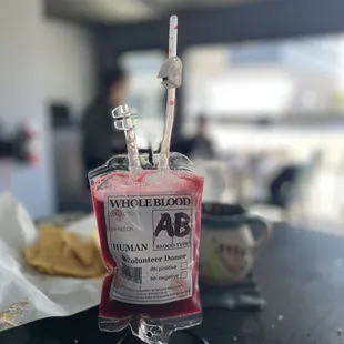 a bag of blood with a spoon sticking out of it