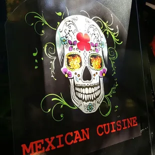 a mexican cuisine truck with a skull painted on it