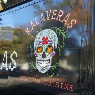 a truck with a skull painted on the side