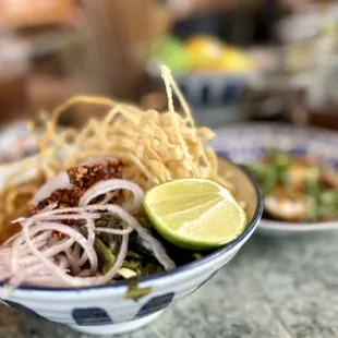 khao soi nua beef khao soi with egg noodles, coconut milk, chili crisp, and crispy noodles