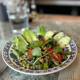 laab ped ground duck salad with crispy duck skin, herbs, chilis and fish sauce,served with sticky rice