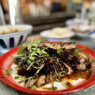 moo yaang prik (grilled mangalitsa pork chop with tamarind, palm sugar and coriander glaze)