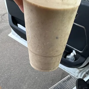 a person holding a smoothie