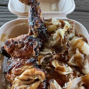 Pork and chicken plate with cabbage and white rice.