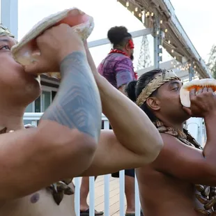 Conch Shell Blowers at a wedding reception to call the guests to the stage. The show is starting!