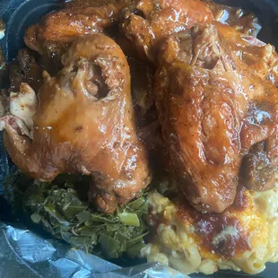 Chicken wings in gravy over rice with Mac &amp; cheese and greens