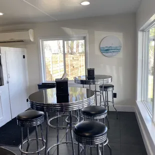 a kitchen with a table and stools