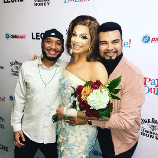 two men and a woman posing for a picture