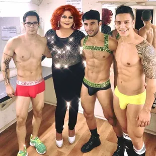 a group of men in underwear posing for a picture