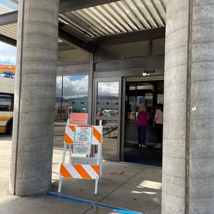 Transit Office entrance. Line forms outside hours 7:30 to 4pm - processing stops at 4pm and may close early.