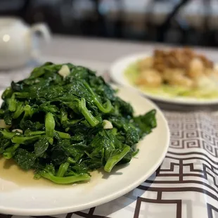 a plate of green vegetables on a table