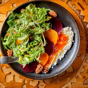 a bowl of food on a wooden table