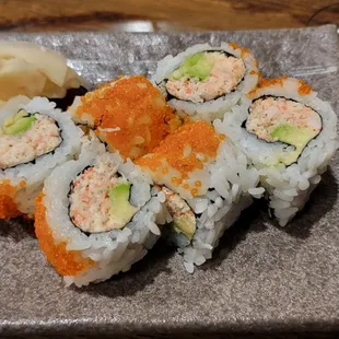 a plate of sushi and a glass of wine