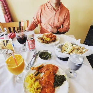 a man sitting at a table with a plate of food