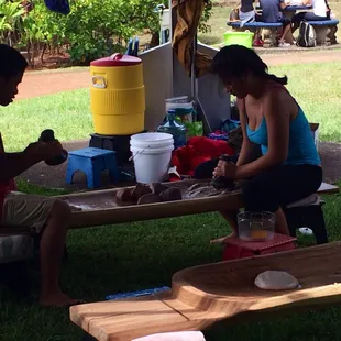 Closer look at students engaged in their poi pounding activity