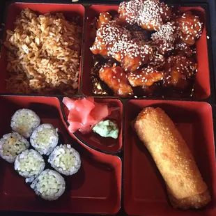 Bento Box: Sesame Chicken, Egg roll, Cucumber roll, and Fried Rice