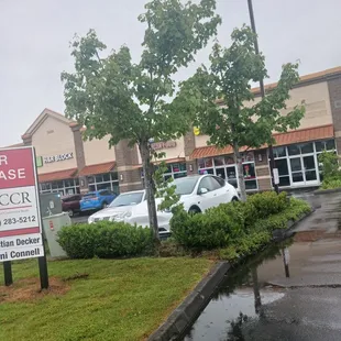 a parking lot with a for lease sign