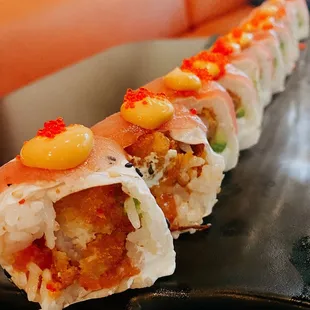 a sushi roll on a black plate