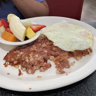 Corned Beef Hash, with over medium eggs and fruit