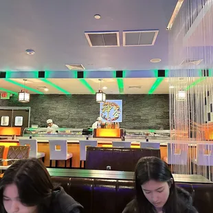 two women sitting at a table in a restaurant