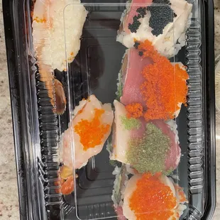 a plastic container of sushi
