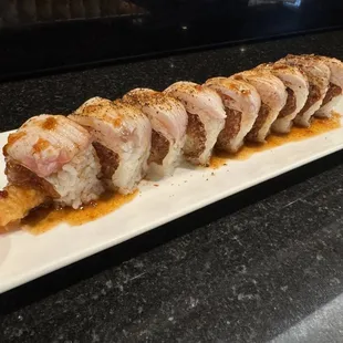 White dragon roll (Shrimp tempura and spicy tuna topped with Seared Yellowtail and spicy Ponzu sauce)