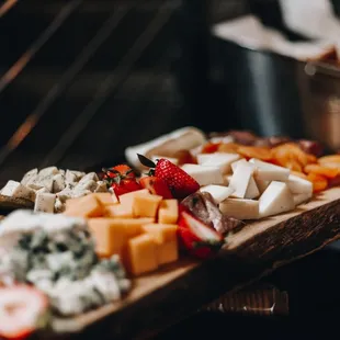 a platter of cheese and fruit